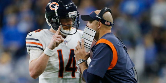 Chicago Bears quarterback Andy Dalton (14) talks with head coach Matt Nagy during the second half of an NFL football game against the Detroit Lions, Thursday, Nov. 25, 2021, in Detroit.