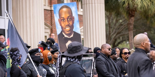 Dozens of Black Lives Matter and Black Panther protesters gather outside the Glynn County Courthouse where the trial of Travis McMichael, his father, Gregory McMichael, and William "Roddie" Bryan is held, Monday, Nov. 22, 2021, in Brunswick, Ga. The three men charged with the February 2020 slaying of 25-year-old Ahmaud Arbery. 