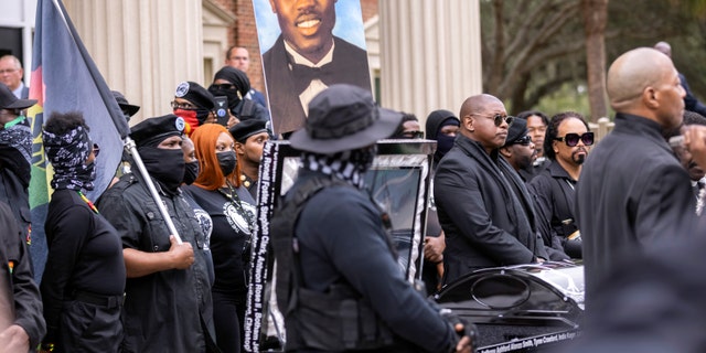 Dozens of Black Lives Matter and Black Panther protesters gather outside the Glynn County Courthouse where the trial of Travis McMichael, his father, Gregory McMichael, and William "Roddie" Bryan is held, Monday, Nov. 22, 2021, in Brunswick, Ga. The three men charged with the February 2020 slaying of 25-year-old Ahmaud Arbery. (AP Photo/Stephen B. Morton)