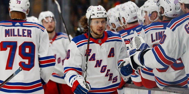 The New York Rangers' Artemi Panarin is congratulated at the bench after scoring against the Boston Bruins during the third period Friday, Nov. 26, 2021, in Boston.