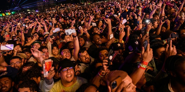 The crowd watches as Travis Scott performs at Astroworld Festival at NRG Park in Houston, Nov. 5, 2021.