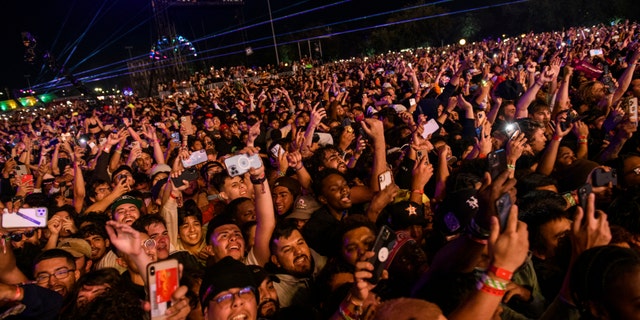 The crowd watches as Travis Scott performs at Astroworld Festival at NRG Park in Houston, Nov. 5, 2021.