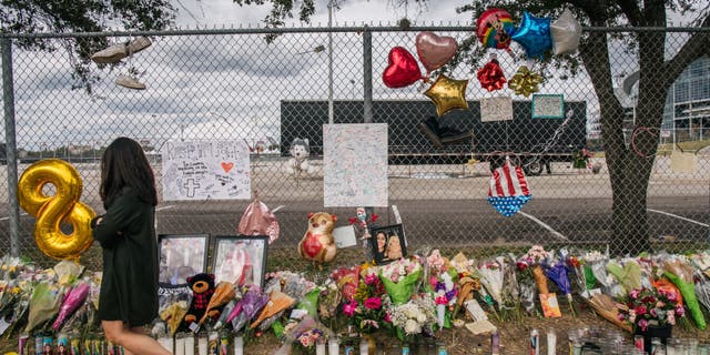 A woman walks past a memorial to those who died at the Astroworld festival outside of NRG Park on Nov. 9, 2021 in Houston, Texas.