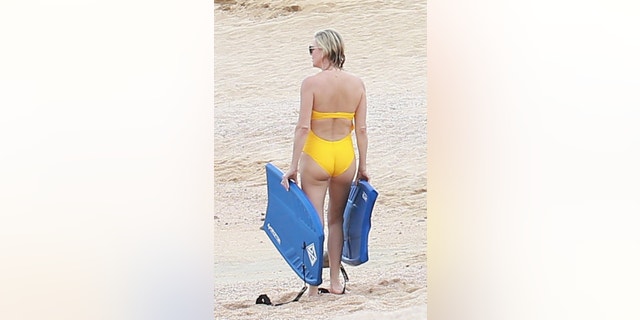 Charlize Theron dutifully keeps track of her family's boogie boards while on vacation in Cabo.