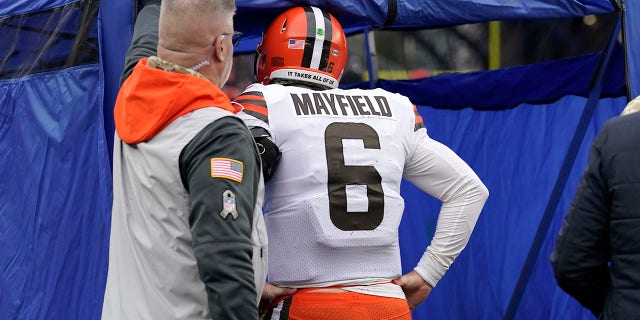Cleveland Browns quarterback Baker Mayfield walks into the medical tent during the Nov. 14, 2021, game against the New England Patriots in Foxborough, Massachusetts.