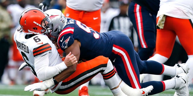 Browns quarterback Baker Mayfield gets dropped by Patriots defensive end Deatrich Wise  Sunday, Nov. 14, 2021, in Foxborough, Massachusetts.