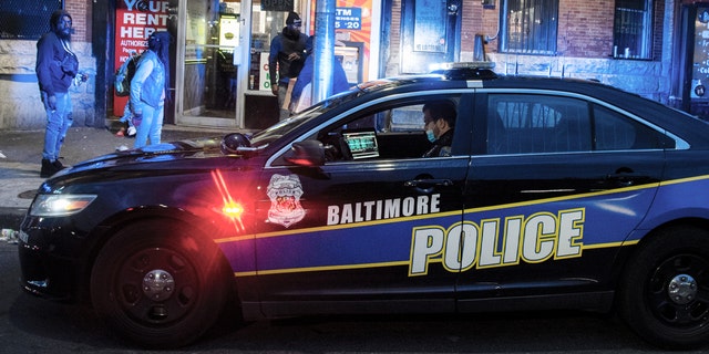 A Baltimore police officer posts himself near the intersection of W. North Avenue and Pennsylvania Avenue in West Baltimore, MD, on Friday, April 17, 2020. 