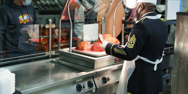 USAG BAUMHOLDER, Germany - The senior leadership from the 21st Theater Sustainment Command serve their Soldiers a Thanksgiving meal at the Knight’s Lair Dining Facility at Baumholder, Germany, Nov. 25, 2021. (U.S. Army)