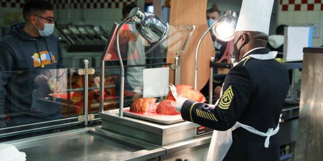 USAG BAUMHOLDER, Germany - The senior leadership from the 21st Theater Sustainment Command serve their Soldiers a Thanksgiving meal at the Knight’s Lair Dining Facility at Baumholder, Germany, Nov. 25, 2021. (U.S. Army)