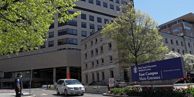 This photo shows medical workers near the East Campus main entrance of Beth Israel Deaconess Medical Center, a Harvard teaching hospital, in Boston on May 14, 2020. The hospital reported that 18% of adults with hypertension reported that they took medication that may increase blood pressure.