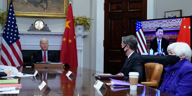 President Joe Biden, left, speaks as he meets virtually with Chinese President Xi Jinping, on screen, from the Roosevelt Room of the White House in Washington, Monday, Nov. 15, 2021. Secretary of State Antony Blinken, center, and Treasury Secretary Janet Yellen, right, also participated in the meeting. (AP Photo/Susan Walsh)