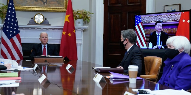 President Joe Biden, left, speaks as he meets virtually with Chinese President Xi Jinping, on screen, from the Roosevelt Room of the White House in Washington, Monday, Nov. 15, 2021. Secretary of State Antony Blinken, center, and Treasury Secretary Janet Yellen, right, also participated in the meeting. (AP Photo/Susan Walsh)