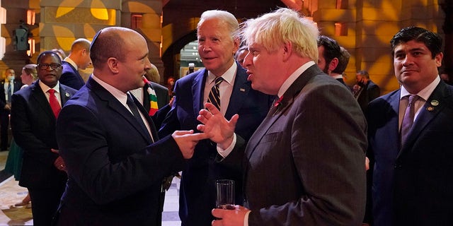 Israel's Prime Minister Naftali Bennett, U.S. President Biden and British Prime Minister Boris Johnson chat as they attend an evening reception to mark the opening day of the COP26 summit at the Scottish Event Campus (SEC) on Nov. 1, 2021, in Glasgow. (Photo by Alberto Pezzali - Pool/Getty Images)