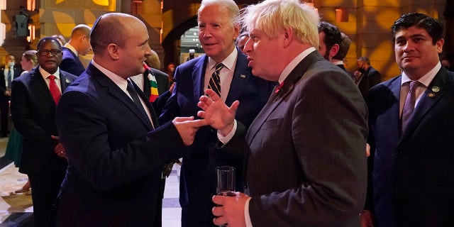 Israel's Prime Minister Naftali Bennett, U.S. President Biden and British Prime Minister Boris Johnson chat as they attend an evening reception to mark the opening day of the COP26 summit at the Scottish Event Campus (SEC) on Nov. 1, 2021, in Glasgow. (Photo by Alberto Pezzali - Pool/Getty Images)