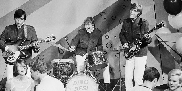 Dancers keep up with the beat provided by a swinging trio composed of Billy Hinsche, Desi Arnaz Jr., and Dino Martin. The musical combo, were known as "Dino, Desi and Billy."