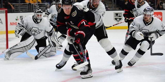 Ottawa Senators left wing Brady Tkachuk plays for the puck against Kings defenseman Alexander Edler (2) and right wing Viktor Arvidsson at Staples Center on Nov. 27, 2021, in Los Angeles.