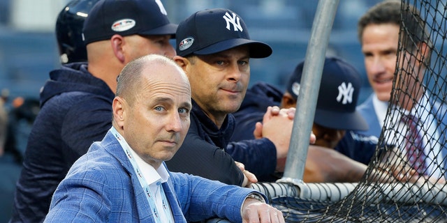 General manager Brian Cashman and manager Aaron Boone of the New York Yankees during batting practice before Game Four of the American League Division Series against the Boston Red Sox at Yankee Stadium on Oct. 9, 2018, ニューヨーク市のブロンクス区で. The Red Sox defeated the Yankees  4-3.