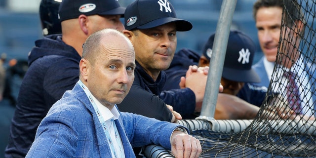 General manager Brian Cashman and manager Aaron Boone of the New York Yankees during batting practice before Game Four of the American League Division Series against the Boston Red Sox at Yankee Stadium on Oct. 9, 2018, in the Bronx borough of New York City. The Red Sox defeated the Yankees 4-3.