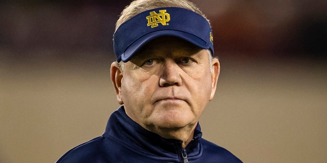Head coach Brian Kelly of the Notre Dame Fighting Irish watches over the team before the game against the Virginia Tech Hokies at Lane Stadium on October 9, 2021 in Blacksburg, Virginia.