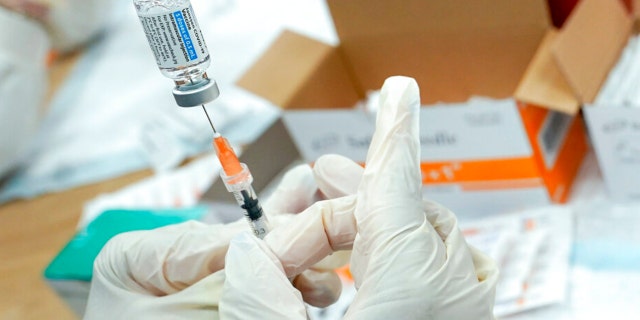 A registered nurse fills a syringe with the Johnson &amp; Johnson COVID-19 vaccine at a pop-up vaccination site in the Staten Island borough of New York, April 8, 2021. New York City officials urged as many people as possible to get COVID-19 booster shots on Monday, Nov. 15, 2021, as officials around the state warned of rising numbers of infections. (AP Photo/Mary Altaffer, File) 