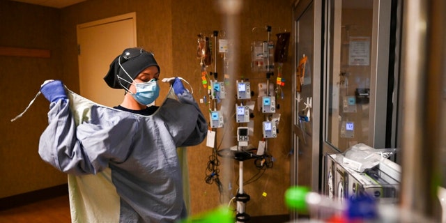 Keila Lynch, a critical care nurse at North Memorial Health Hospital, wore a protective gown during the shift on December 7, 2020, before entering the COVID-19 patient's room. 