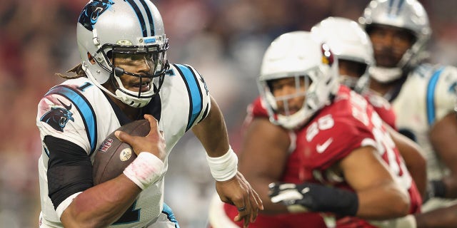 GLENDALE, ARIZONA - NOVEMBER 14: Quarterback Cam Newton #1 of the Carolina Panthers scrambles with the football against the Arizona Cardinals during the fourth quarter of the NFL game at State Farm Stadium on November 14, 2021 in Glendale, Arizona. The Panthers defeated the Cardinals 34-10.