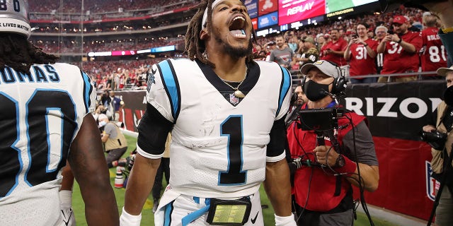 GLENDALE, ARIZONA - NOVEMBER 14: Cam Newton #1 of the Carolina Panthers reacts after scoring on a rushing touchdown against the Arizona Cardinals in the first quarter at State Farm Stadium on November 14, 2021 in Glendale, Arizona.