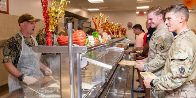CAMP LEMONNIER, Djibouti – U.S. Navy Capt. David Faehnle, commanding officer, Camp Lemonnier, Djibouti (CLDJ), serves a Thanksgiving meal to deployed service members on Nov. 25, 2021. (U.S. Navy photo by Mass Communication Specialist 2nd Class Jonathan Word)