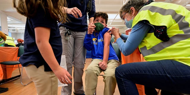 File photo: A child reacts while being administered the Pfizer and Biontech coronavirus disease (COVID-19) vaccine at the Smoketown Family Wellness Center in Louisville, Kentucky, USA, November 8, 2021. REUTERS/Jon Cherry/File Photo