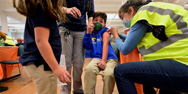 File photo: A child reacts while being administered the Pfizer and Biontech coronavirus disease (COVID-19) vaccine at the Smoketown Family Wellness Center in Louisville, Kentucky, USA, November 8, 2021.  REUTERS/Jon Cherry/File Photo