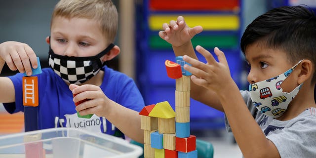 Children wear masks and wait for President Biden to visit their pre-kindergarten class at East End Elementary School to highlight the early childhood education proposal in his Build Back Better infrastructure agenda in North Plainfield, New Jersey, on Oct. 25, 2021. 