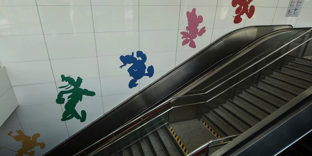 Disney characters on a wall next to the escalator inside a closed subway station at the Shanghai Disney Resort in Shanghai, China, on Monday.