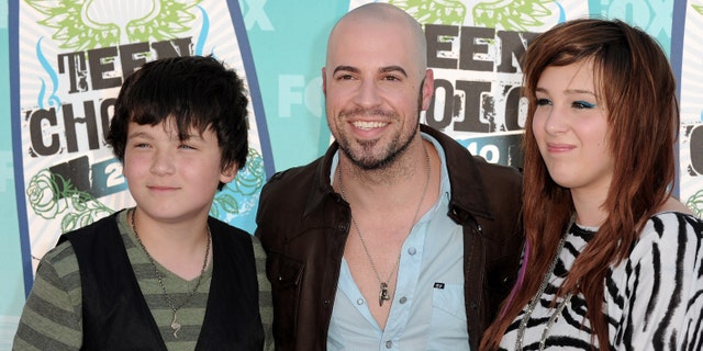 Chris Daughtry poses with his stepchildren Griffin and Hannah Daughtry.