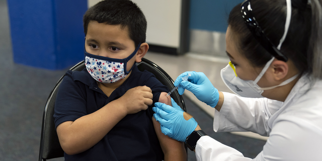 Eric Aviles, 6, receives the Pfizer COVID-19 vaccine from pharmacist Sylvia Uong at a pediatric vaccine clinic for children ages 5 to 11 set up at Willard Intermediate School in Santa Ana, Calif., on Nov. 9.