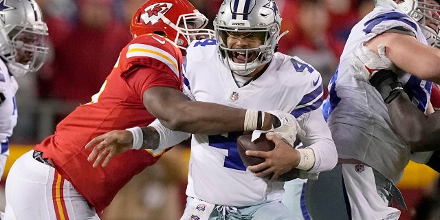 Dallas Cowboys quarterback Dak Prescott (4) is sacked by Kansas City Chiefs defensive tackle Chris Jones during the second half of an NFL football game Sunday, Nov. 21, 2021, in Kansas City, Missouri.