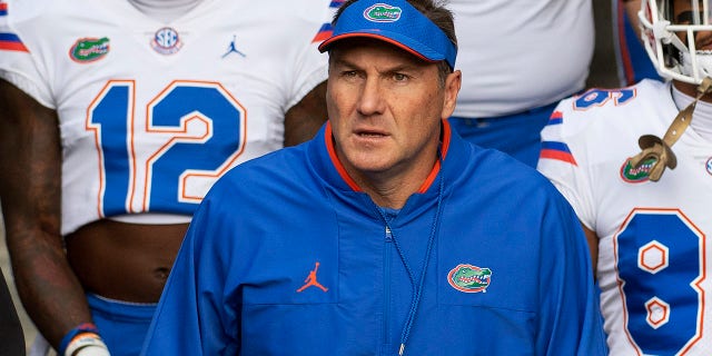 Florida head coach Dan Mullen walks with his team to the field prior to an NCAA college football game against Missouri, Saturday, Nov. 20, 2021, in Columbia, Mo.