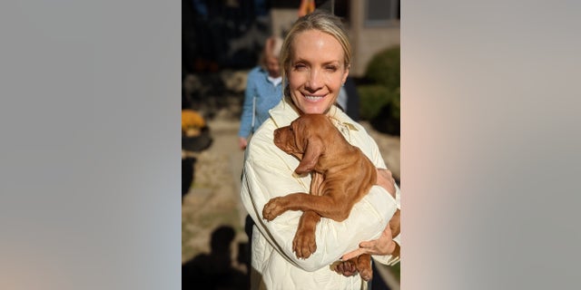 Dana Perino holding her new dog, Percy, during his early puppy days. She introduced him to Fox News viewers in Nov. 2021. 