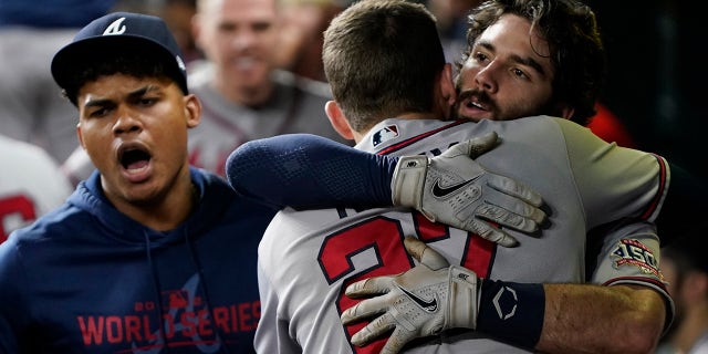 Atlanta Braves' Dansby Swanson celebrates a two-run home run with Austin Riley during the fifth inning in Game 6 of baseball's World Series between the Houston Astros and the Atlanta Braves Tuesday, Nov. 2, 2021, in Houston.