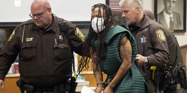 Darrell Brooks, center, is escorted out of the courtroom after making his initial appearance, Tuesday in Waukesha County Court in Waukesha, Wisconsin. 