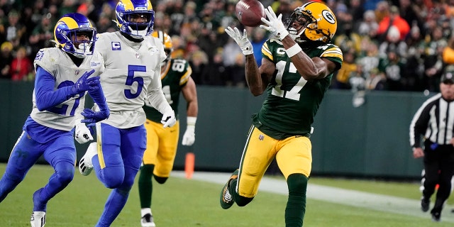 Green Bay Packers' Davante Adams catches a long pass in front of Los Angeles Rams' Jalen Ramsey Sunday, Nov. 28, 2021, in Green Bay, Wisconsin.