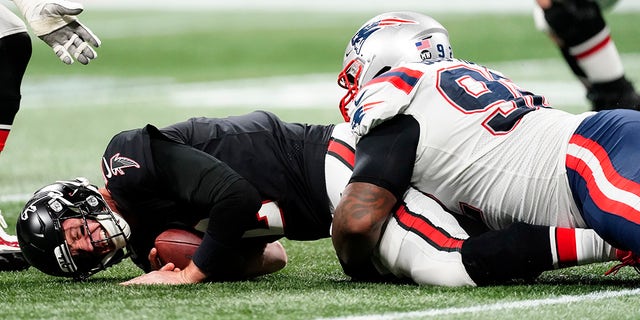 Atlanta Falcons quarterback Matt Ryan (2) is sacked by New England Patriots nose tackle Davon Godchaux (92) during the second half of an NFL football game, Thursday, Nov. 18, 2021, in Atlanta. 