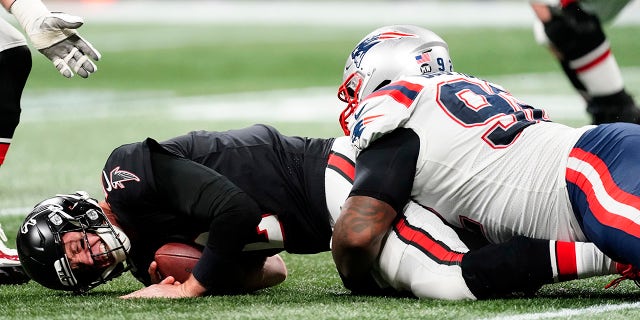 Atlanta Falcons quarterback Matt Ryan (2) is sacked by New England Patriots nose tackle Davon Godchaux (92) during the second half of an NFL football game, Thursday, Nov. 18, 2021, in Atlanta.