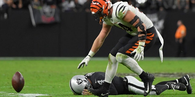 Cincinnati Bengals defensive end Sam Hubbard (94) recovers a fumble by Las Vegas Raiders quarterback Derek Carr (4) during the second half of an NFL football game, Sunday, Nov. 21, 2021, in Las Vegas.