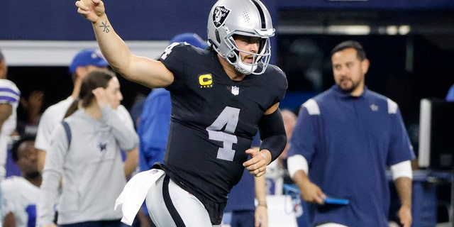 Las Vegas Raiders quarterback Derek Carr celebrates running the ball for a first down in the second half of an NFL football game against the Dallas Cowboys in Arlington, Texas on Thursday, November 25, 2021 .