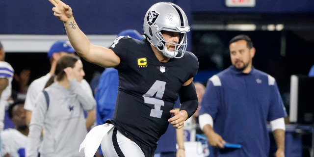 Las Vegas Raiders quarterback Derek Carr celebrates running the ball for a first down in the second half of an NFL football game against the Dallas Cowboys in Arlington, Texas on Thursday, November 25, 2021 .