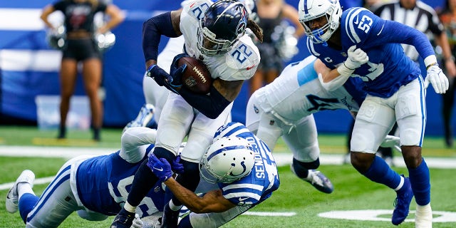 Tennessee Titans running back Derrick Henry (22) is tackled by Indianapolis Colts safety Andrew Sendejo (42) in the second half of an NFL football game in Indianapolis, Sunday, Oct. 31, 2021.