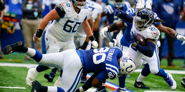 Tennessee Titans running back Derrick Henry (22) is tackled by Indianapolis Colts defensive tackle Grover Stewart (90) in the first half of an NFL football game in Indianapolis, Sunday, Oct. 31, 2021.