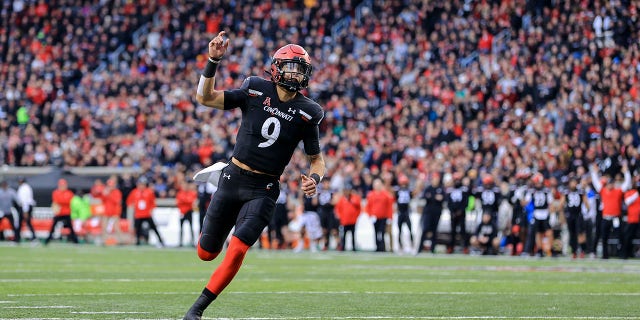 Cincinnati quarterback Desmond Ridder celebrates a touchdown against SMU on Nov. 20, 2021, in Cincinnati.