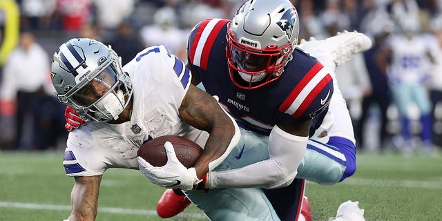 Ced Wilson of the Dallas Cowboys is tackled by Devin McCourty of the New England Patriots in the second quarter at Gillette Stadium on Oct. 17, 2021, in Foxborough, Massachusetts.