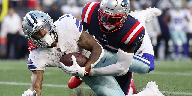 Ced Wilson #1 of the Dallas Cowboys is tackled by Devin McCourty #32 of the New England Patriots in the second quarter at Gillette Stadium on October 17, 2021 in Foxborough, Massachusetts.
